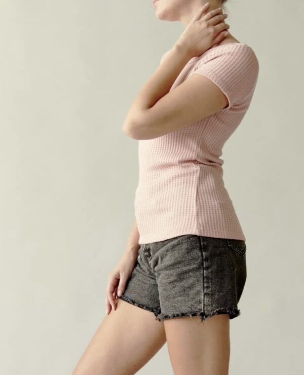 A woman in black shorts and pink shirt